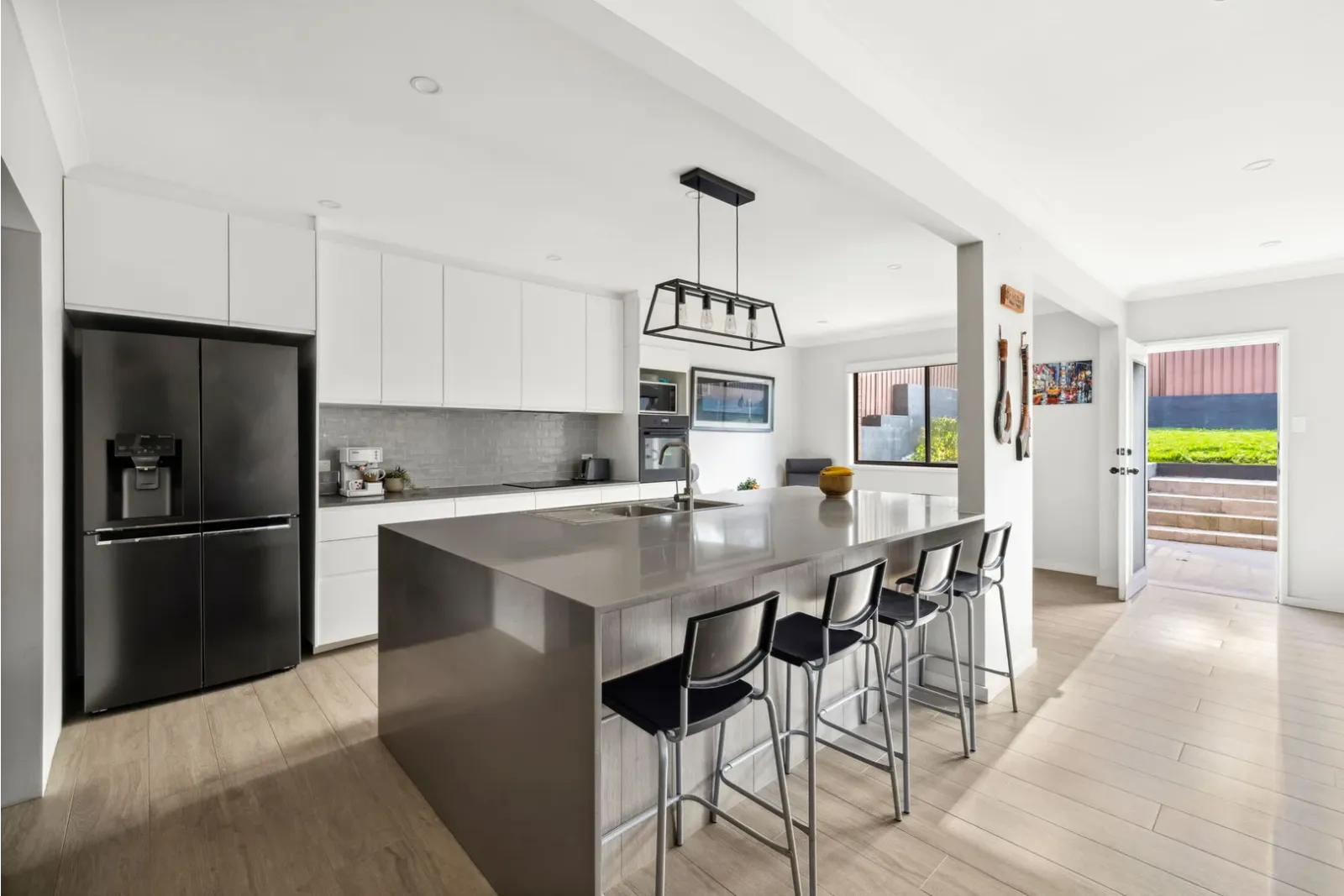 Modern kitchen renovation with a spacious island bench, sleek cabinetry, and open-plan living design.